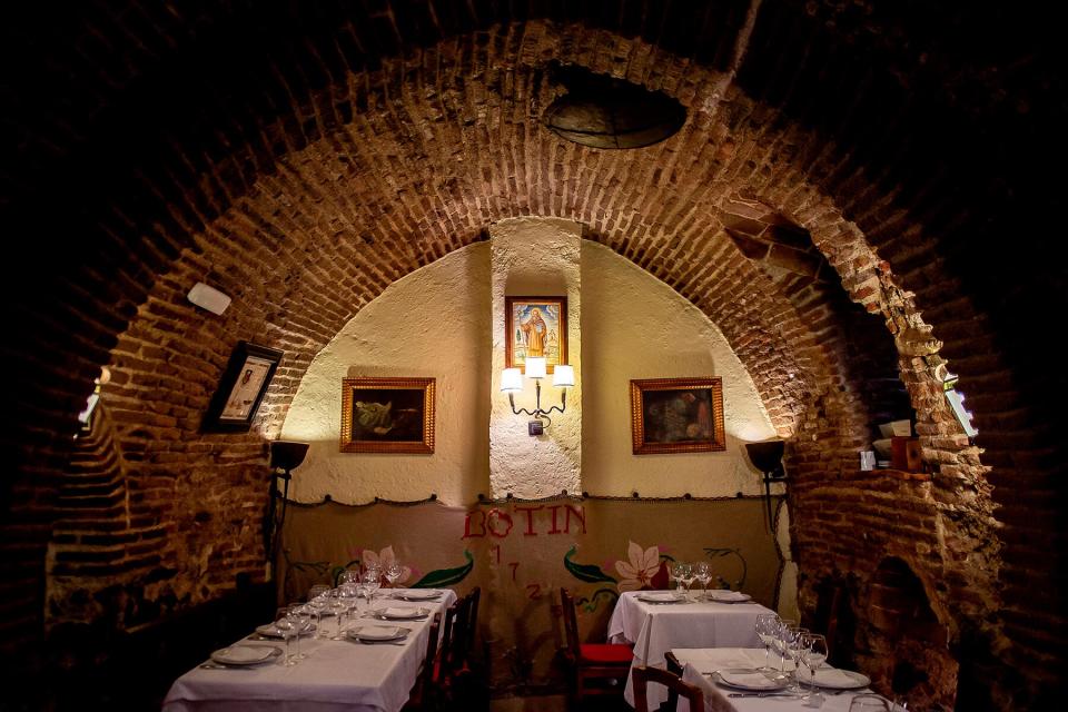 Tables are set for diners in one of the rooms of the restaurant 'Sobrino de Botin'