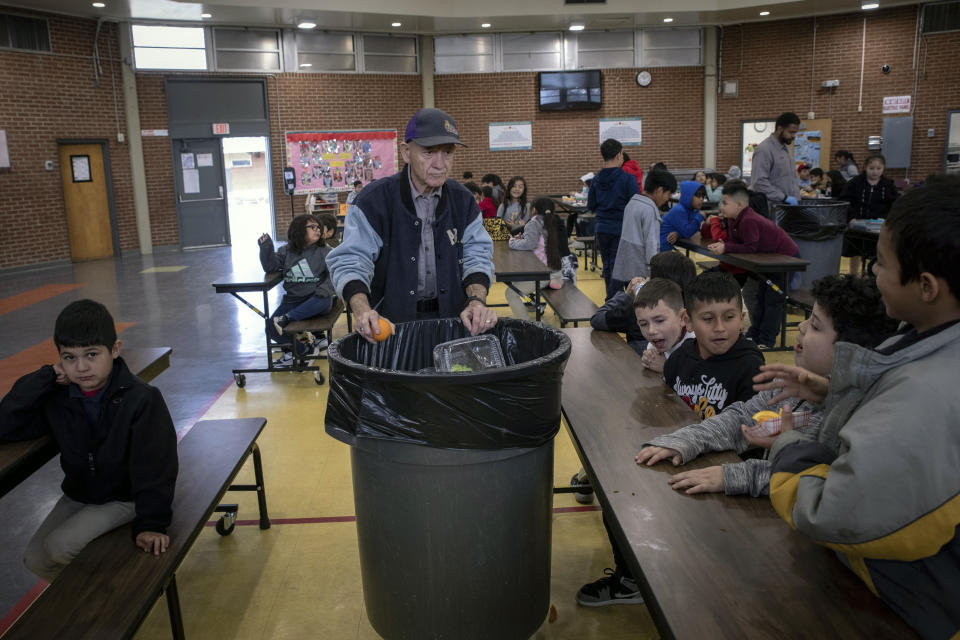 Students dispose of their unfinished food at the end of lunch break at V. H. Lassen Academy of Science and Nutrition in Phoenix, Tuesday, Jan. 31, 2023, in Phoenix. (AP Photo/Alberto Mariani)