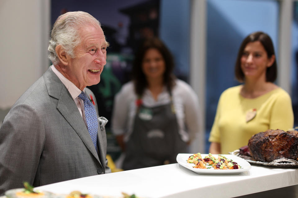 <p>King Charles III laughs with supermarket staff during an official visit to Yorkshire. (Getty)</p> 