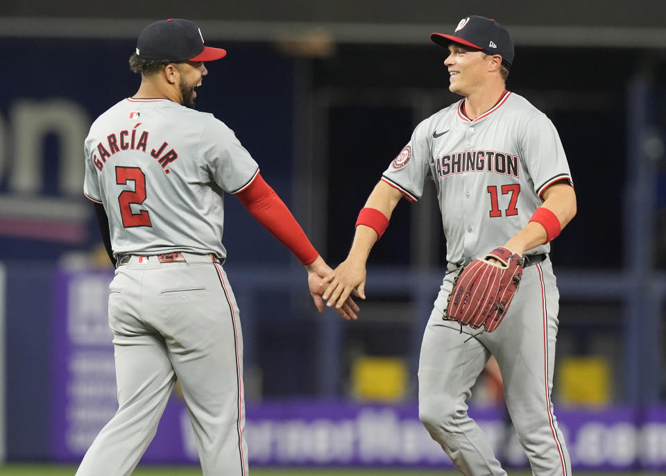 Washington Nationals second baseman Luis García Jr. (2) and center fielder Alex Call (17) celebrate after a baseball game against the Miami Marlins, Saturday, April 27, 2024, in Miami. The Nationals won 11-4. (AP Photo/Marta Lavandier)