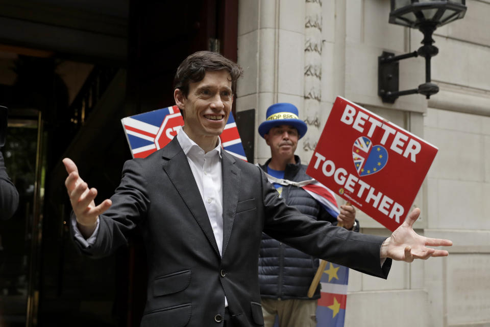 British ruling Conservative party leadership and Prime Minister contender Rory Stewart reacts to seeing awaiting media as he leaves television news network studios in London, Wednesday, June 19, 2019. Britain's Conservative Party are set to kick one more candidate out of the contest to become the country's next prime minister, as rivals scramble to catch front-runner Boris Johnson. The five-strong field will be narrowed in elimination votes by Tory lawmakers Wednesday and Thursday, with the two top candidates going to a runoff of party members across the country. (AP Photo/Matt Dunham)