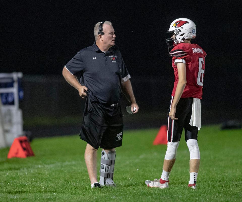 Stillman Valley's head coach Mike Lalor talks to Kale Rauman on the sidelines on Friday, Aug. 26, 2022, at Stillman Valley High School in Stillman Valley.