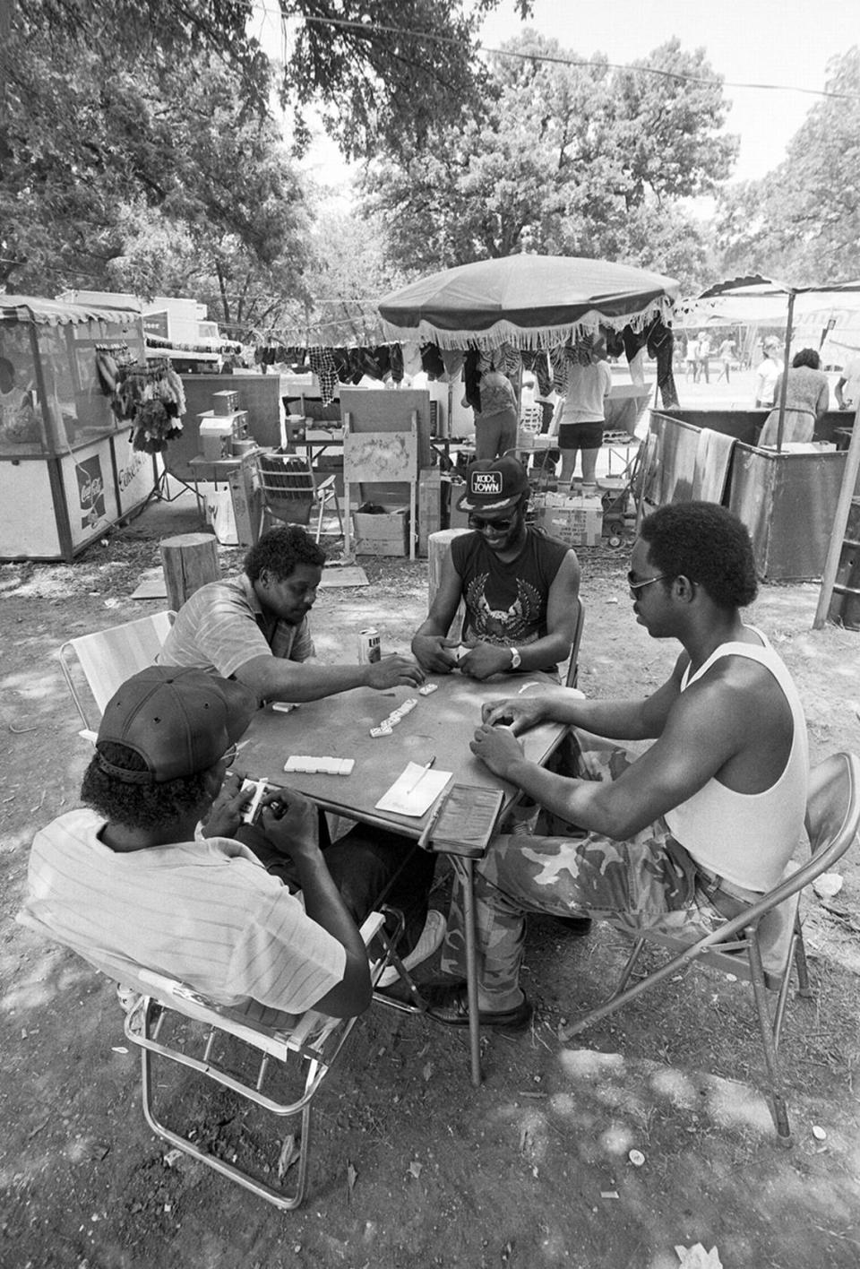 A group of men play dominoes during Juneteenth festivities at Sycamore Park in Fort Worth in 1985