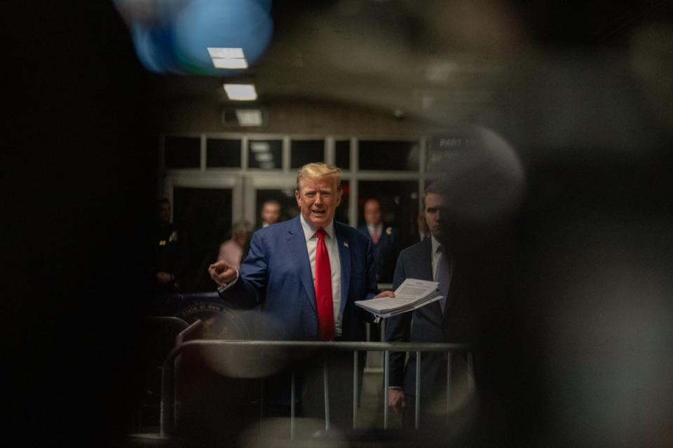 Donald Trump speaks to reporters inside the criminal courthouse in Manhattan on 10 May (POOL/AFP via Getty Images)