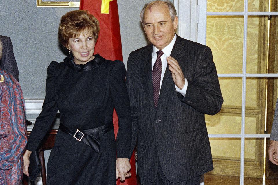 FILE - Soviet leader Mikhail Gorbachev, holds his wife Raisa's hand as they arrive at the State Department in Washington on Dec. 9, 1987 for a luncheon in their honor. When Mikhail Gorbachev is buried Saturday at Moscow's Novodevichy Cemetery, he will once again be next to his wife, Raisa, with whom he shared the world stage in a visibly close and loving marriage that was unprecedented for a Soviet leader. Gorbachev's very public devotion to his family broke the stuffy mold of previous Soviet leaders, just as his openness to political reform did. (AP Photo/Doug Mills, File)