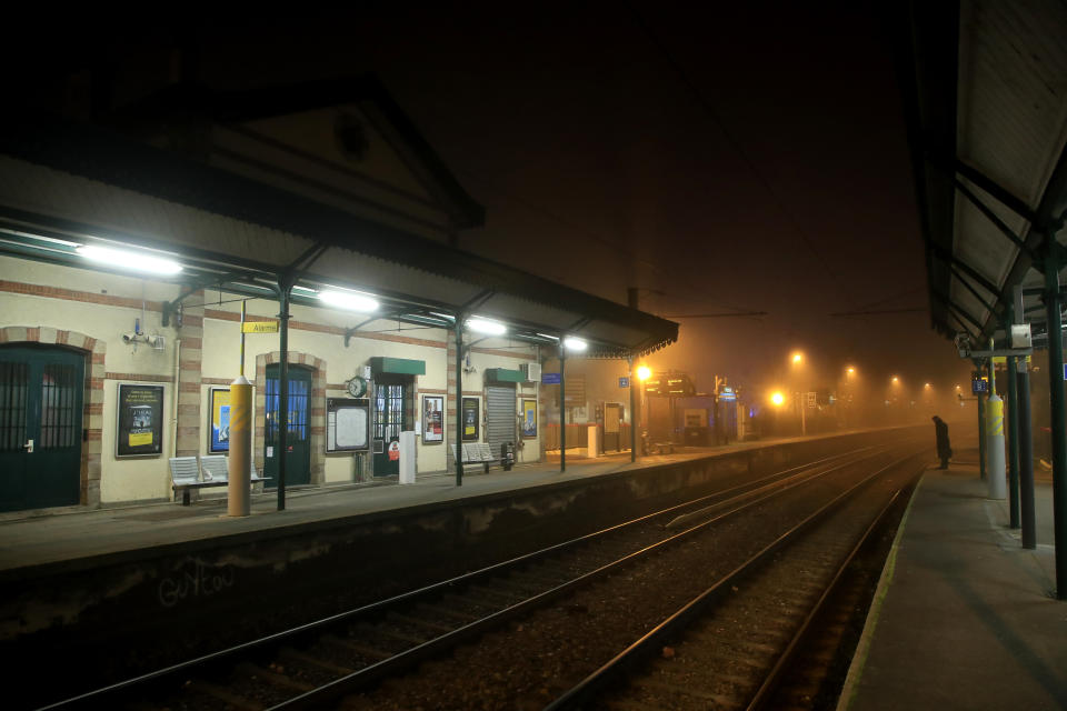 A man waits on the platform of Louveciennes train station, west of Paris, Thursday, Dec. 5, 2019. Tourists are canceling travel plans and Paris is deploying thousands of police as France girds for massive, nationwide strikes and protests against President Emmanuel Macron's plans to overhaul the retirement system. Transport will be hardest hit by the walkout, with flights, trains and buses canceled and most of the Paris subway system coming to a halt. (AP Photo/Michel Euler)