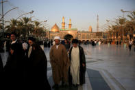 Shi'ite clerics walk outside the Imam Hussein and Imam Abbas shrines in Kerbala, Iraq, August 19, 2017. REUTERS/Abdullah Dhiaa Al-deen