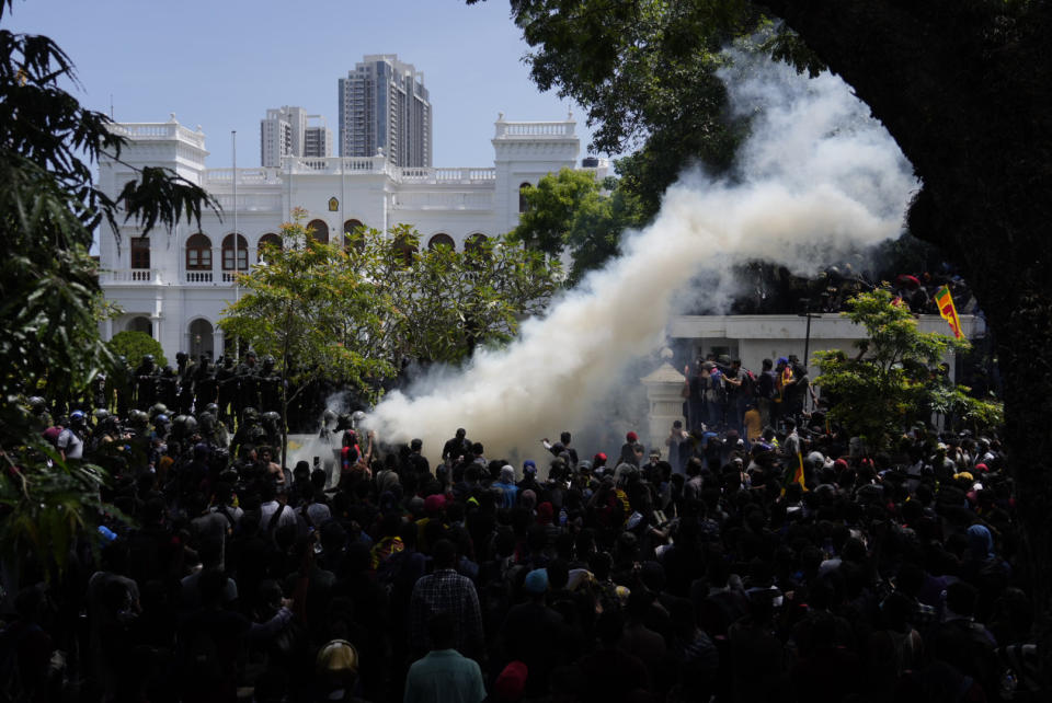 Police use teargas as Sri Lankan protesters storm the compound of prime minister Ranil Wickremesinghe 's office, demanding he resign after president Gotabaya Rajapaksa fled the country amid economic crisis in Colombo, Sri Lanka, Wednesday, July 13, 2022. (AP Photo/Rafiq Maqbool)