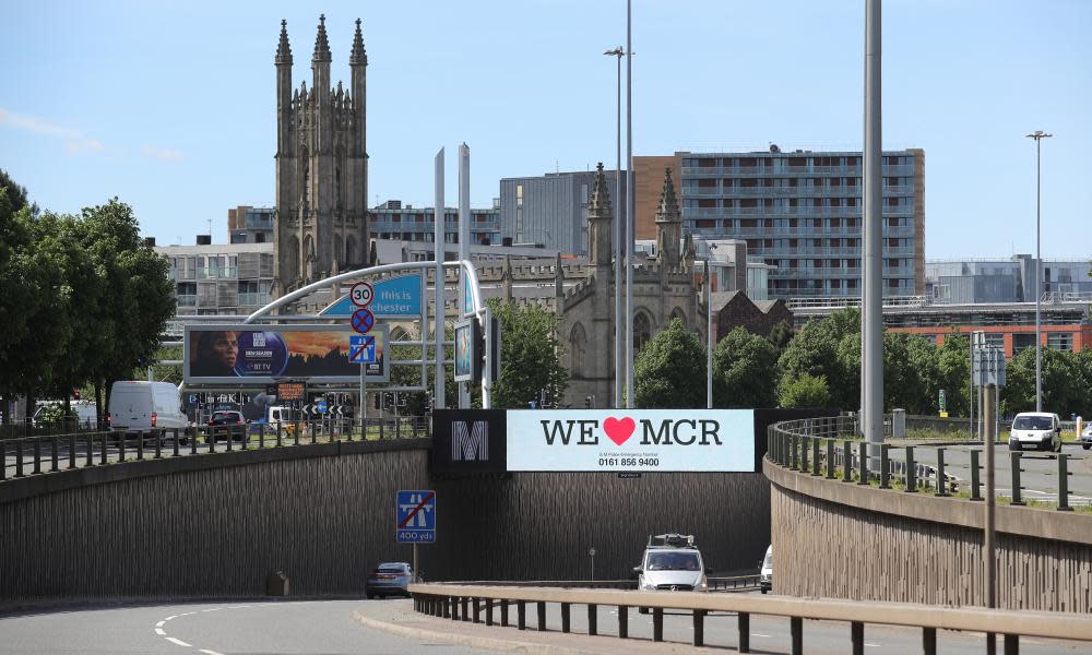 A giant TV screen displays the 'We Love Manchester