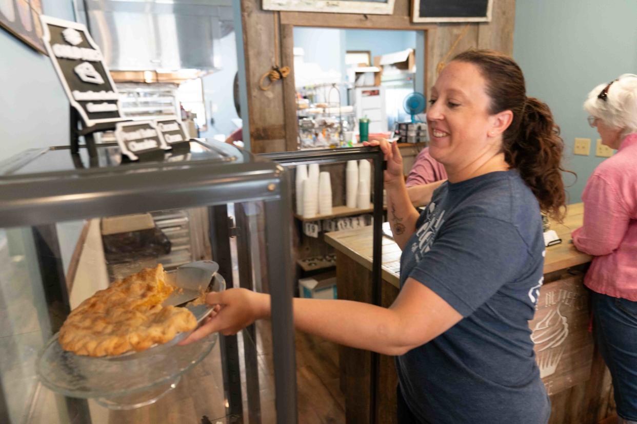 Aunt Netters Cafe owner Annette Nally places a peach pie back in a cabinet Thursday. The pies here have put the Lecompton cafe on the map after making it to USA Today's 10Best Pie Shops category recently.