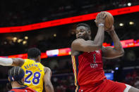 New Orleans Pelicans forward Zion Williamson (1) pulls down a rebound against Los Angeles Lakers forward Rui Hachimura (28) in the first half of an NBA basketball play-in tournament game Tuesday, April 16, 2024, in New Orleans. (AP Photo/Gerald Herbert)