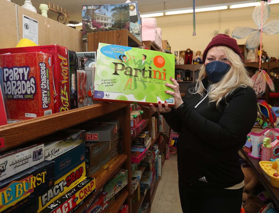 Catherine Altizer, the store manager at the Happy Tails Thrift Shop that benefits the Humane Society of Summit County, says games and puzzles are a popular purchase at the store in Akron.