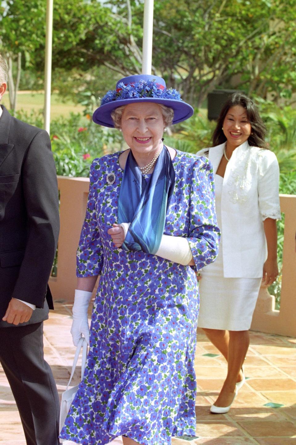 The Queen wears her plaster cast arm in a sling while visiting Anguilla (Martin Keene/PA)