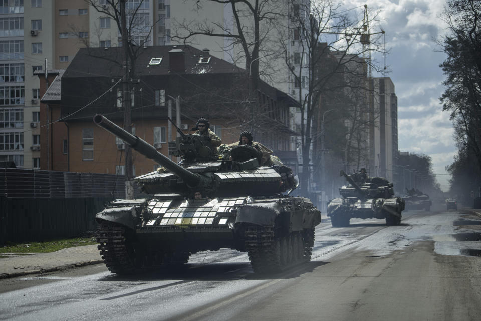 Ukrainian tanks move in a street in Irpin, in the outskirts of Kyiv, Ukraine, Monday, April 11, 2022. (AP Photo/Evgeniy Maloletka)