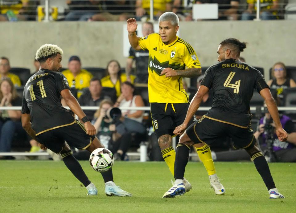 Aug 25, 2024; Columbus, Ohio, USA; 
Columbus Crew forward Cucho Hernández (9) is defended by Los Angeles FC midfielder Timothy Tillman (11) and Los Angeles FC defender Eddie Segura (4) before scoring a second goal in the Leagues Cup Final at Lower.com Field. 
Mandatory Credit: Barbara Perenic-USA TODAY Sports