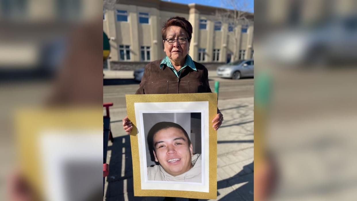 Virginia Pierre holds a photo of her nephew, Dale Culver, outside the Prince George courthouse in 2023.  (Betsy Trumpener/CBC - image credit)