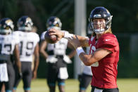 Jacksonville Jaguars quarterback Trevor Lawrence looks for a receiver during an NFL football practice, Sunday, July 31, 2022, in Jacksonville, Fla. (AP Photo/John Raoux)