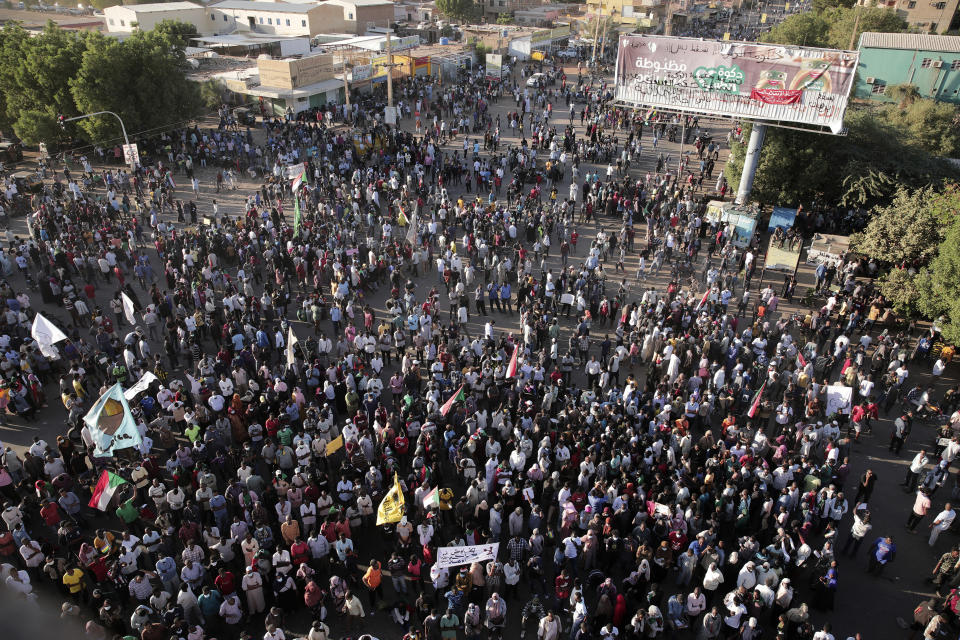 Thousands of protesters take to the streets to renew their demand for a civilian government in the Sudanese capital Khartoum, Thursday, Nov. 25, 2021. The rallies came just days after the military signed a power-sharing deal with the prime minister, after releasing him from house arrest and reinstating him as head of government. The deal came almost a month after the generals orchestrated a coup. Sudan's key pro-democracy groups and political parties have dismissed the deal as falling short of their demands for a fully civilian rule. (AP Photo/Marwan Ali)