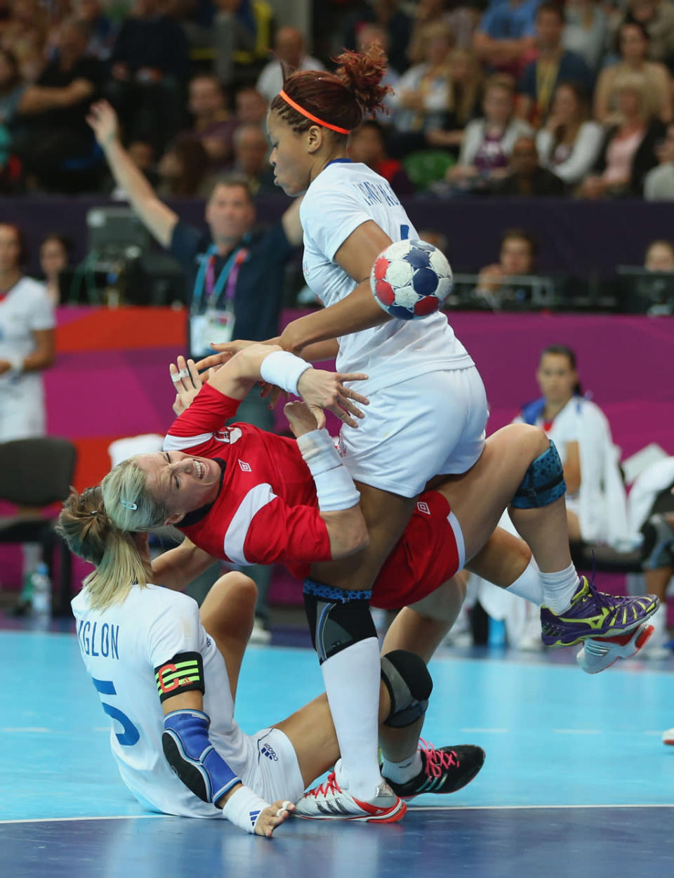 Heidi Loke of Norway clashes with Camille Ayglon and Alexandra Lacrabere of France in the Women's Handball preliminaries Group B - Match 6 between Norway and France on Day 1 of the London 2012 Olympic Games at the Copper Box on July 28, 2012 in London, England. (Photo by Jeff Gross/Getty Images)