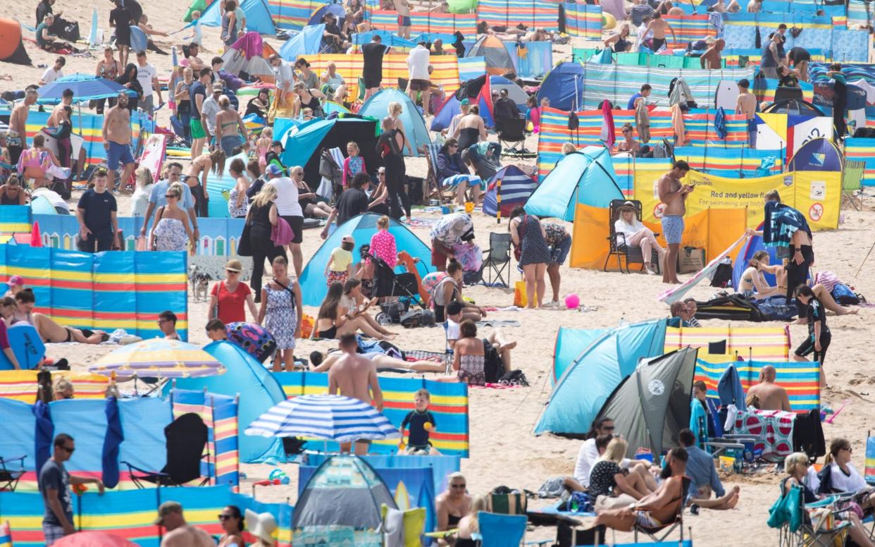 People enjoy the hot weather on Fistral Beach, Cornwall, on a very hot day in the southwest - Tom Nicholson/LPN