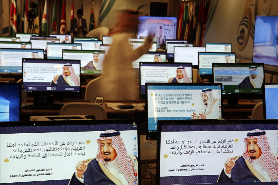 Screensavers showing King Salman are visible on computers at the press center for upcoming summits, in Mecca, Saudi Arabia, Thursday, May 30, 2019. Salman convenes Arab heads of state from the Gulf and Arab League to discuss escalation in tension with Iran. Arabic on computers reads, "Despite all the challenges facing our Arab nation. We are optimistic about a promising future that fulfills the hopes of our nations for leadership." (AP Photo/Amr Nabil)