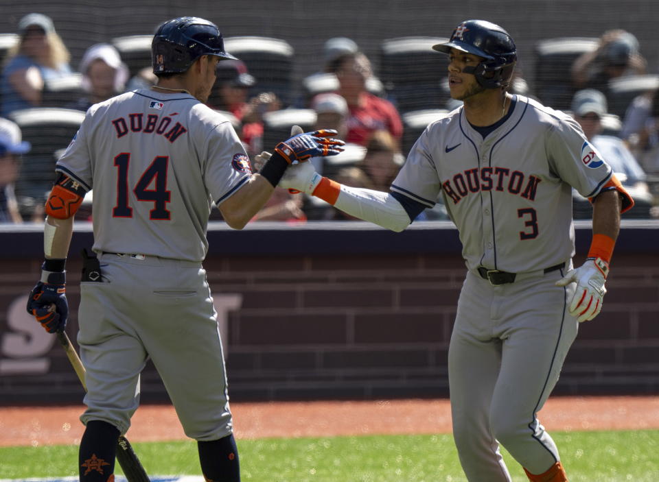 Houston Astros' Jeremy Peña (3) is congratulated by teammate Mauricio Dubón after hitting a solo home run against the Toronto Blue Jays in fifth-inning baseball game action in Toronto, Monday, July 1, 2024. (Frank Gunn/The Canadian Press via AP)