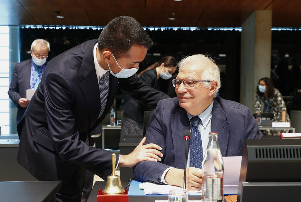 Italy's Foreign Minister Luigi Di Maio, left, talks to European Union foreign policy chief Josep Borrell during a European Foreign Affairs Ministers meeting at the European Council building in Luxembourg, Monday, June 21, 2021. EU foreign ministers were set to approve Monday a new set of sanctions against scores of officials in Belarus and prepare a series of measures aimed at the country's economy. (Johanna Geron/Pool Photo via AP)