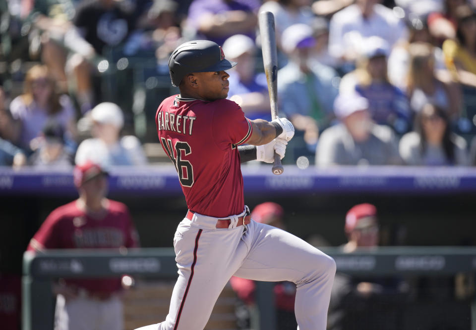 Arizona Diamondbacks' Stone Garrett follows the flight of his single to drive in two runs off Colorado Rockies starting pitcher Ryan Feltner in the third inning of a baseball game Sunday, Sept. 11, 2022, in Denver. (AP Photo/David Zalubowski)