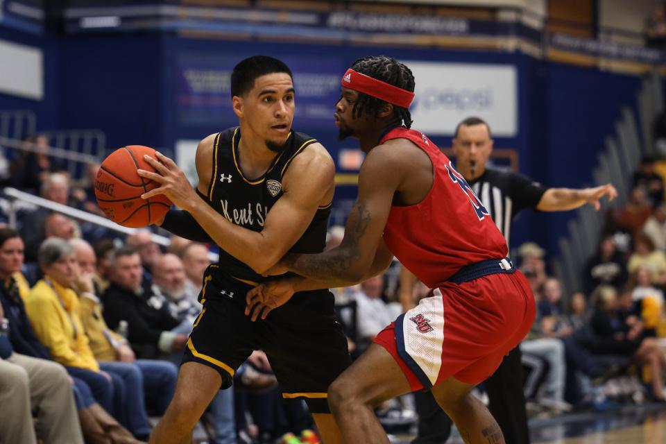 Kent State guard Giovanni Santiago looks to get past Malone guard Maijhe Wiley during Monday night’s basketball game.