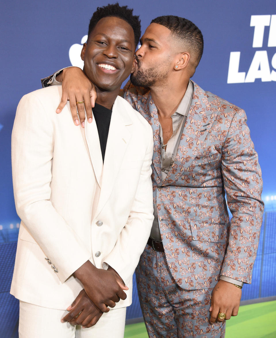 <p>Toheeb Jimoh and Kola Bokinni share a smooch at a FYC screening of <em>Ted Lasso </em>at The Maybourne Beverly Hills on July 18.</p>