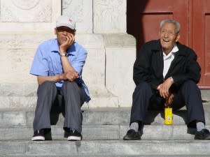 Two old men sitting on the steps