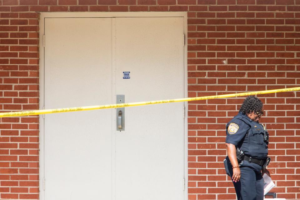 A Memphis Police Department officer walks through the scene at Margolin Hebrew Academy after a man armed with a handgun first tried to enter the school and then began firing his gun outside the school before fleeing in Memphis, Tenn., on Monday, July 31, 2023.