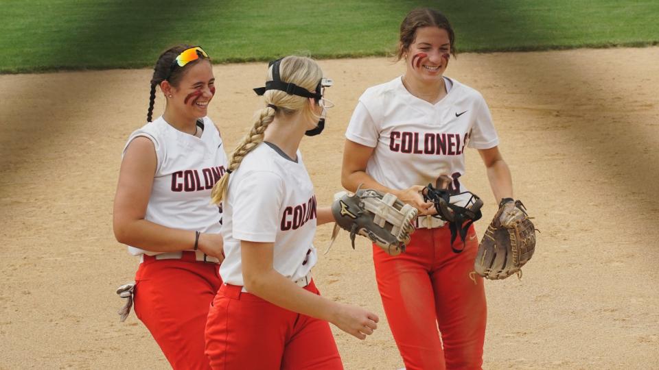 Dixie Heights' Ella Steczynski (right) celebrates with Skylar Mitchell (left) and Ava Niemer (center) after making a diving play in the sixth inning of the Ninth Region championship on May 28, 2023.