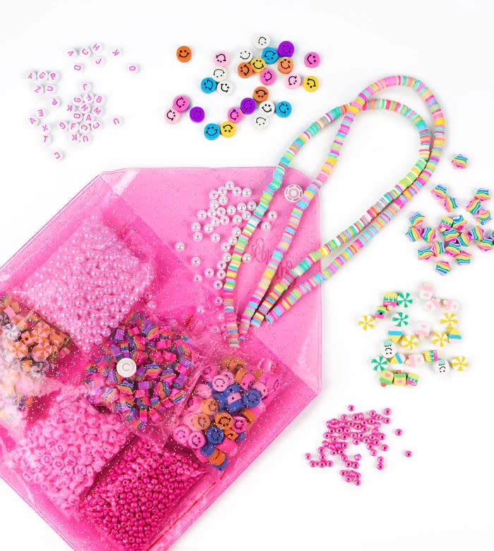 pink carrying case with beads and bracelets