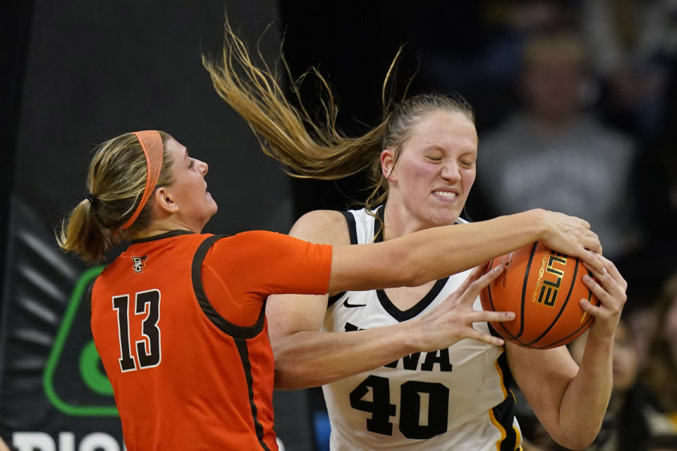 Bowling Green forward Olivia Hill (13) fights for a rebound with Iowa center Sharon Goodman (40) during the second half of an NCAA college basketball game, Saturday, Dec. 2, 2023, in Iowa City, Iowa. Iowa won 99-65. (AP Photo/Charlie Neibergall)