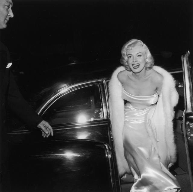 1954:  EXCLUSIVE American actor Marilyn Monroe (1926  - 1962) emerges from a car, wearing a strapless white gown and white fur coat at the premiere of director Walter Lang&#39;s film &#39;There&#39;s No Business Like Show Business&#39;.  (Photo by M. Garrett/Murray Garrett/Getty Images)
