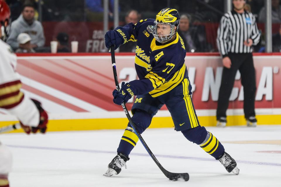 Michigan defenseman Marshall Warren (77) shoots the puck against Boston College during the first period of the Frozen Four semifinal game at Xcel Energy Center in St. Paul, Minn. on Thursday, April 11, 2024.