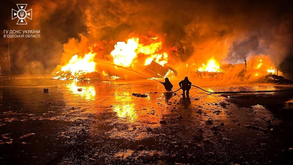 Firefighters working to extinguish a fire on the port infrastructure on the Danube river, in the Odesa region (AFP via Getty Images)