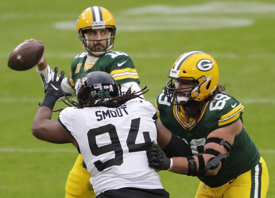 Green Bay Packers defensive tackle David Bakhtiari (69) blocks <a class="link " href="https://sports.yahoo.com/nfl/teams/jacksonville/" data-i13n="sec:content-canvas;subsec:anchor_text;elm:context_link" data-ylk="slk:Jacksonville Jaguars;sec:content-canvas;subsec:anchor_text;elm:context_link;itc:0">Jacksonville Jaguars</a> defensive end <a class="link " href="https://sports.yahoo.com/nfl/players/30181" data-i13n="sec:content-canvas;subsec:anchor_text;elm:context_link" data-ylk="slk:Dawuane Smoot;sec:content-canvas;subsec:anchor_text;elm:context_link;itc:0">Dawuane Smoot</a> (94)) as quarterback Aaron Rodgers (12) looks to pass Sunday, November 15, 2020, at Lambeau Field in Green Bay, Wis.<br>Apc Packvsjaguars 1113200600