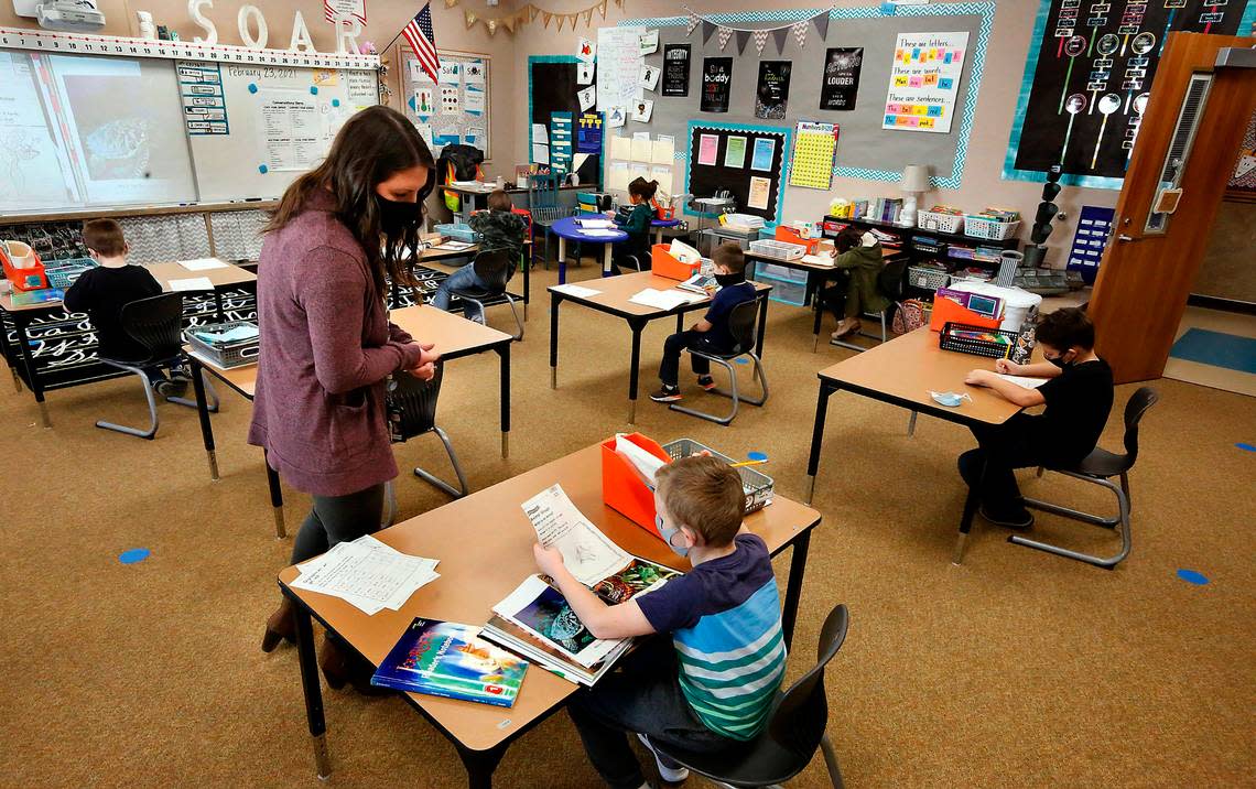 Students sit in spaced apart desks in a first-grade classroom at McClintock STEM Elementary in Pasco during the hybrid model class schedule during the coronavirus pandemic.