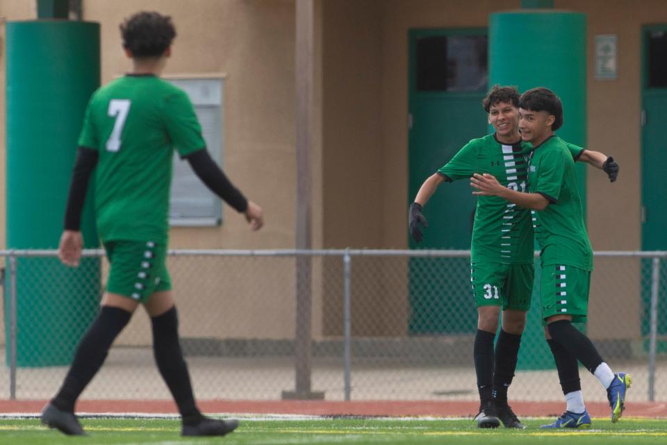 Victor Valley's Ismael Estrada, center, celebrates with teammate Jonathan Guzman after scoring the team's second goal of the match against Roybal in the first half. Victor Valley defeated Roybal 2-0 in the first round of the CIF State Southern California Regional Division 5 playoffs on Tuesday, Feb. 28, 2023.