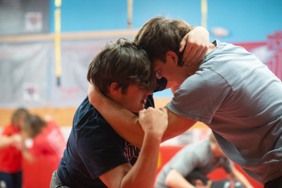 Shawnee Heights seniors Garrett Peery, left, and Matthew Etzel take turns pinning each other in short matches to begin Wednesday's practice.