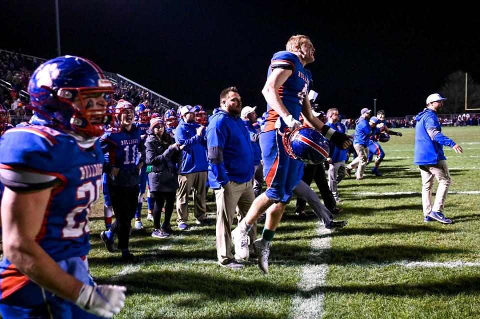 Mason celebrates after beating DeWitt on Friday, Nov. 3, 2023, at Mason High School.