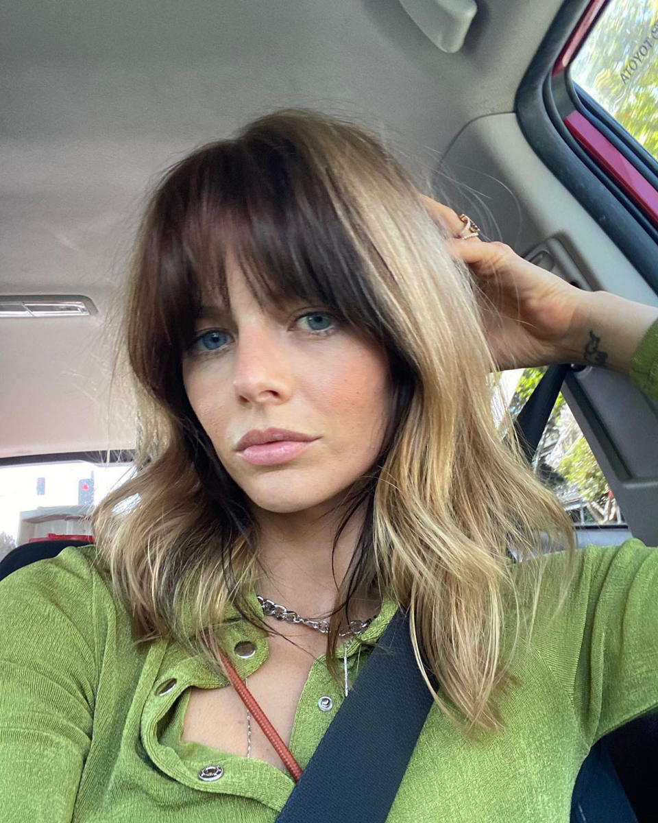 Samara Weaving in a green top showing off her brunette and blonde hair