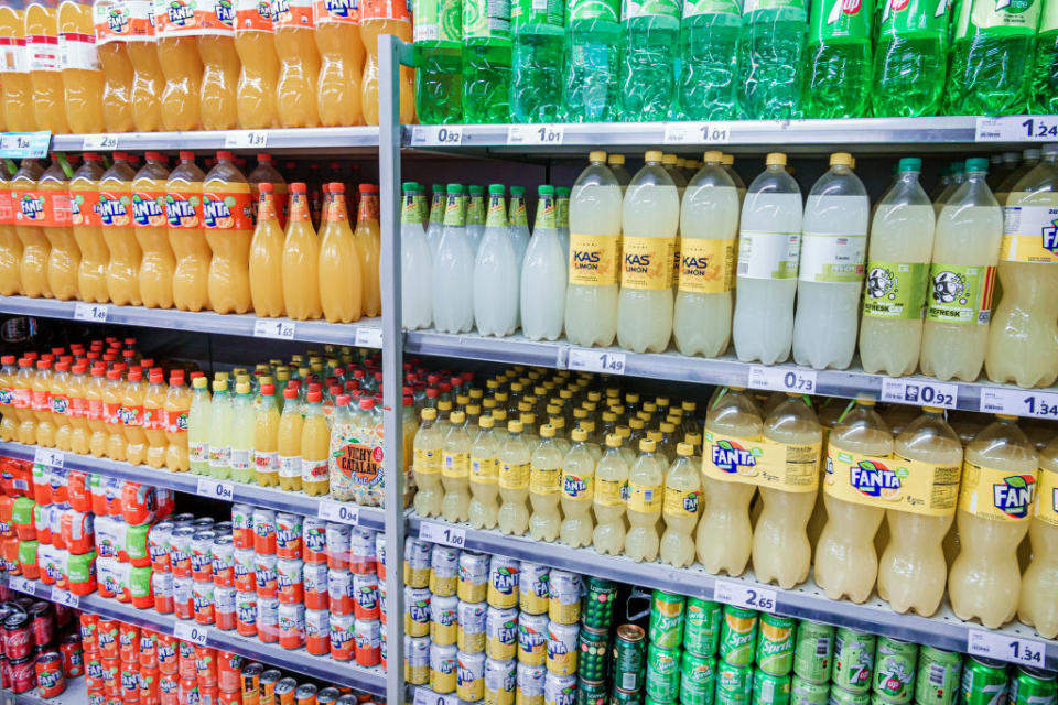 store shelves showing rows and rows of flavored sodas