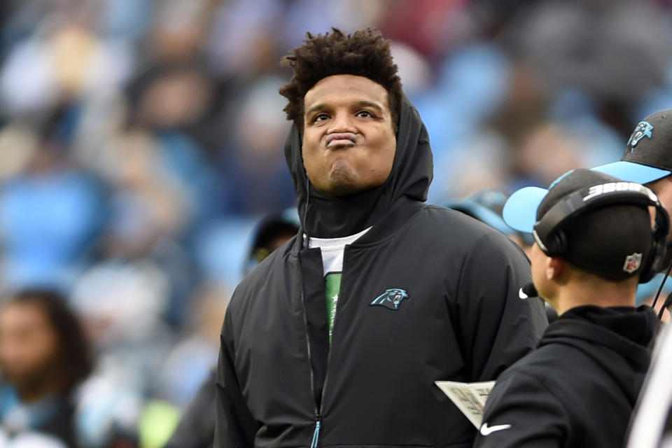 Cam Newton watches the action from the sideline during a Panthers game.