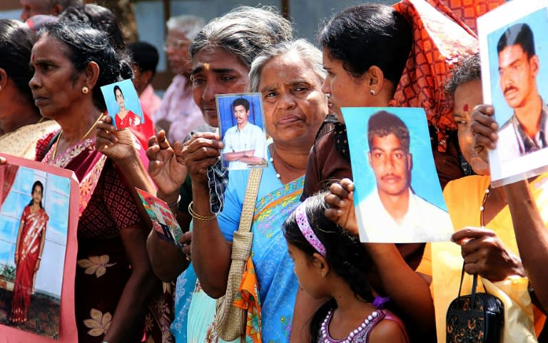 Tamil protesters hold photographs of missing relatives during a 2013 demonstration in the northern Sri Lankan town of Jaffna