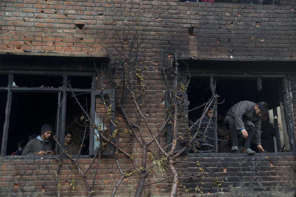 A burnt peach tree stands by a house damaged in a gunbattle in Tral, south of Srinagar, Indian controlled Kashmir, Friday, May 24, 2019. Government forces in Indian-controlled Kashmir killed a top militant commander linked to al-Qaida in the disputed region, officials said on Friday. (AP Photo/ Dar Yasin)