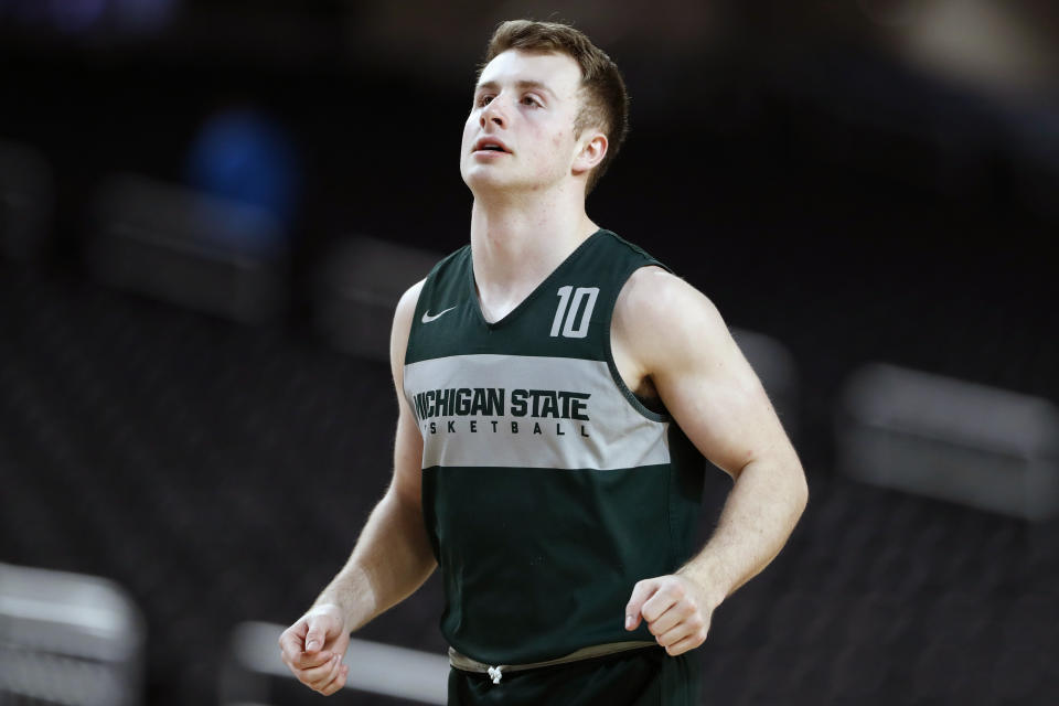 FILE - In this April 5, 2019, file photo, Michigan State guard Jack Hoiberg runs on the court during a practice session for the semifinals of the Final Four NCAA college basketball tournament in Minneapolis. Fred and Jack Hoiberg will be on opposite benches when Nebraska hosts Michigan State on Thursday night, Feb. 20, 2020. Fred is in his first year as the Cornhuskers' coach, and his son Jack is a reserve guard for the Spartans. (AP Photo/Jeff Roberson, File)