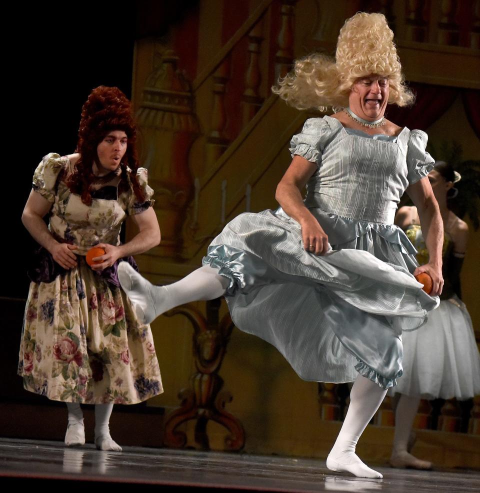 Jeff Boze of Holland, Ohio, dances as Josh Mohler of Monroe watches while at the ball in the River Raisin Ballet Company's production of "Cinderella" at the River Raisin for the Arts. Boze and Mohler are playing the stepsisters.